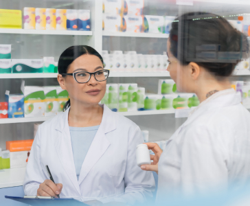 tattooed-pharmacist-in-white-coat-holding-bottle-n-2023-10-10-04-01-55-utc-1.jpg